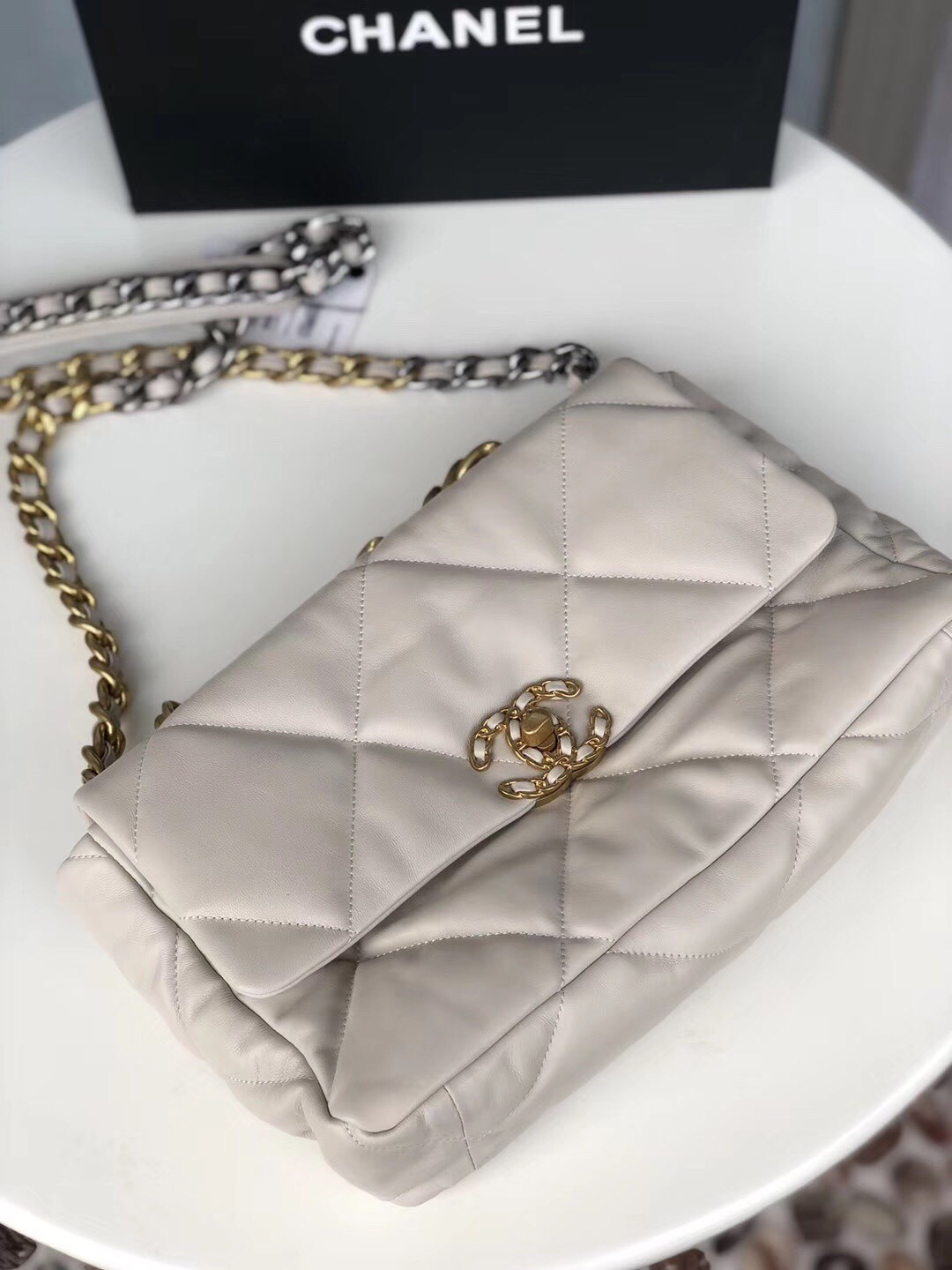 Ch*el 19 large handbag shiny leather, gold-tone, silver-tone & ruthenium-finish metal beige 7.8 × 11.7 × 3.9 in